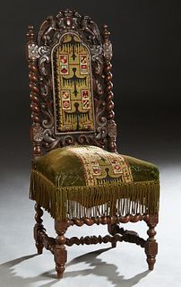 French Louis XIII Style Carved Oak Side Chair, c. 1880, the pierced winged gryphon crest over the high back with a central needlepoint cushioned panel