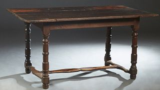 French Provincial Louis XIV Style Carved Oak Farmhouse Table, 18th c., the three board top over a wide skirt, on turned tapered and block legs joined 
