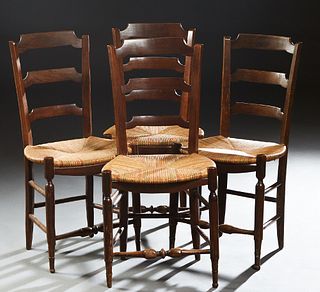 Set of Four French Provincial Carved Beech Rushseat Dining Chairs, late 19th c., the canted curved ladder back over a bowfront rush seat, on turned ta