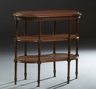 French Louis XVI Style Carved Walnut Desserte, early 20th c., the inset oval highly figured rouge marble over a carved skirt, on turned reeded support