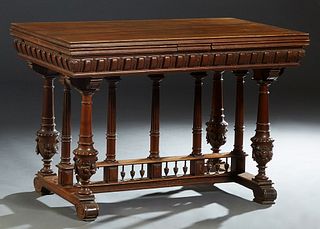 French Provincial Henri II Style Carved Walnut Drawleaf Dining Table, late 19th c., the reeded edge top over a geometric relief carved skirt, with two