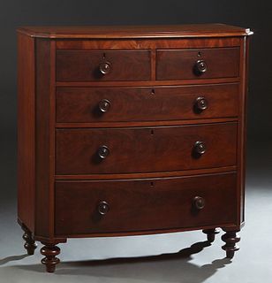 English Carved Mahogany Bowfront Chest, 19th c, the stepped canted corner top over two frieze drawers and three deep drawers, flanked by canted pilast