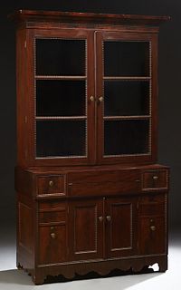 American Classical Carved Mahogany Secretary Bookcase, 19th c., the stepped ogee crown over double mullioned glazed doors, on a base with a fold out s