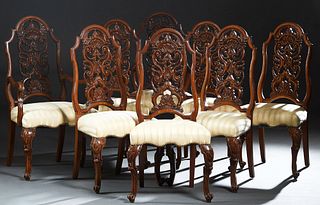 American English Style Carved Walnut Set of Eight (6 +2) Dining Chairs, 20th c., the arched intricately pierce carved backs over trapezoidal cushioned