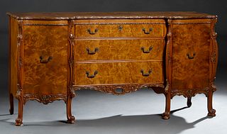American English Style Burled Walnut Sideboard, early 20th c., the serpentine carved edge top over a central bank of three drawers, flanked by serpent
