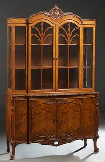 American English Style Carved Walnut Breakfront China Cabinet, 20th c., the double arched crown over double arched mullioned glazed doors, flanked by 