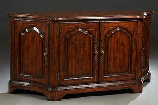 Lloyd Buxton Carved Walnut Four Door Sideboard, late 20th c., the stepped rounded edge curved top over double fielded panel cupboard doors, flanked by