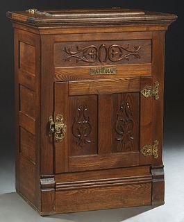 National Carved Oak Icebox, early 20th c., the lifting lid over a removable galvanized interior, the front panel with applied carving over a door with