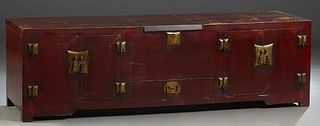 Chinese Red Lacquered Low Cabinet, late 19th c., the rectangular top with a central locking lifting lid over a lower drawer, flanked by double cupboar