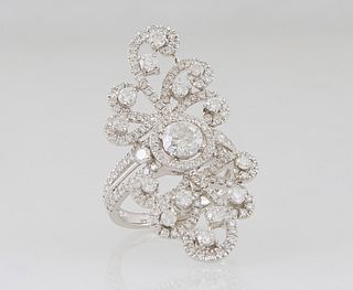 Lady's Platinum Dinner Ring, with a central .7 ct. round diamond, flanked by diamond mounted pierced scrolls on the top and bottom, the pierced should