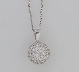 14K White Gold Pendant, of domed form, the domed side mounted with numerous small round diamonds, on a 14K white gold tiny oval link chain, total diam