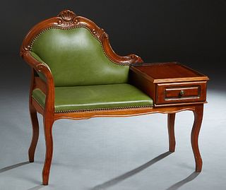 French Carved Mahogany Telephone Bench, 20th c., the arched shell carved back over a proper right rolled arm, and a proper left telephone table with a