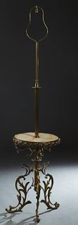 French Empire Style Brass and Onyx Floor Lamp, early 20th c, with a harp and a single light over a reeded support to a center circular brass bound ony