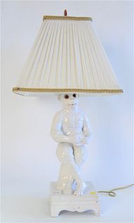 White Porcelain Crowned Seated Monkey, having red glass eyes, on square base, made into a table lamp, monkey height 16 inches.