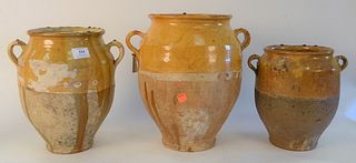 Group of Ten French Earthenware Glazed Confit Jars, with handles in mustard yellow drip glaze, height 13 1/2 inches.