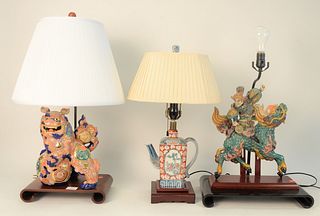 Three Piece Lot of Chinese and Japanese Table Lamps, to include one porcelain foo dog on a scroll base; one porcelain warrior riding a dragon on black