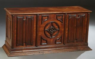 French Provincial Carved Mahogany Coffer, late 19th c., the lifting top over a front with an applied carved center panel, flanked by relief linenfold 