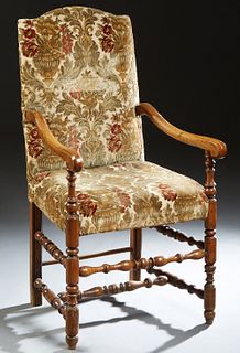 French Louis XIII Style Carved Elm Fauteuil, 19th c., the arched canted rectangular back over scrolled arms, to a cushioned seat, on turned tapered le