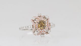 Lady's 18K White Gold Dinner Ring, with a .53 ct. yellowish-green cushion cut diamond, atop a border of pink diamonds and a pierced outer border of pi