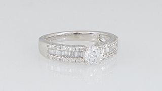 Lady's Platinum Dinner Ring, with a central round .4 ct. diamond, flanked by shoulders with a central band of baguette diamonds within borders of tiny