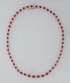 14K Yellow Gold Link Necklace, each of the fifty links with a graduated oval ruby atop a border of round diamonds, total ruby wt.- 27.54 cts., total d