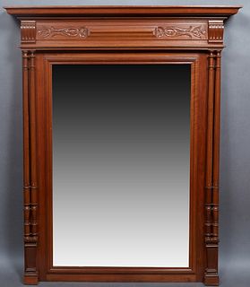 French Henri II Style Carved Walnut Overmantel Mirror, c. 1880, with a stepped ogee crown over a floral incised frieze, above a setback rectangular pl