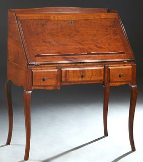 French Provincial Carved Cherry Slant Front Secretary, 20th c., the 3/4 galleried top over a slant lid opening to an interior fitted with drawers and 