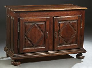 French Louis XIII Style Carved Walnut Sideboard, 19th c., the stepped rounded edge and corner top over double cupboard doors with applied geometric de