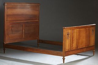 French Carved Walnut Louis XVI Style Double Bed, c. 1900, the arched crown headboard over a long horizontal panel, to wooden rails and a footboard wit