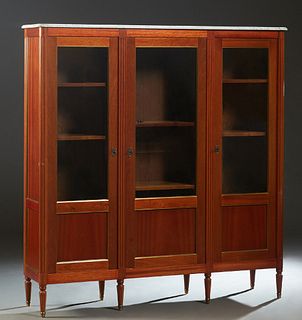 French Louis XVI Style Carved Mahogany Ormolu Mounted Bookcase, early 20th c., the figured cookie corner ogee edge white marble over three doors with 