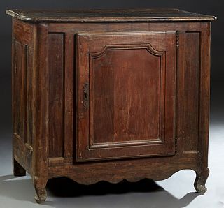 French Provincial Louis XIV Style Carved Beech Confiturier, 19th c., the rounded edge and corner three board top over a large cupboard door with a lon