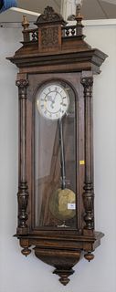 Regulator Clock having walnut case, enameled dial and brass works.