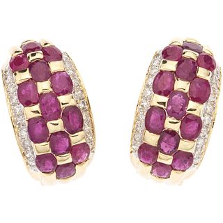 PAIR OF EARRINGS WITH RUBIES AN DIAMONDS IN 14K YELLOW GOLD 26 Oval cut rubies ~3.90 ct, 40 Brilliant cut diamonds ~0.57 ct