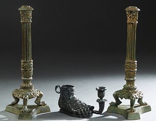 Three Patinated Bronze Empire Style Pieces, 20th/21st c., consisting of a pair of columnar candlesticks on tripodal paw feet to a tripartite plinth; a