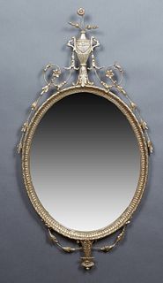 French Style Silvered Wood and Iron Overmantel Mirror, 20th c., with an urn and floral surmount above a wide beveled oval plate, H.- 50 1/2 in., W.- 2