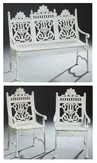 Three Piece American Victorian Cast Iron Patio Set, late 19th c., consisting of a settee and two armchairs, with pierced floral relief crests over pie