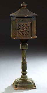 Cast Iron Mailbox, 20th/21st c., of house form with relief decorated sides, on a stepped turned tapered support, to a square base, H.- 44 in., W.- 13 