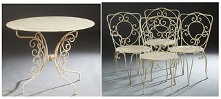 French Wrought iron Five Piece Patio Set, 20th c., consisting of a circular table with pierced decoration, on scrolled legs, and four matching armchai