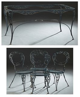 Five Piece Wrought Iron Dining Set, 20th/21st c., consisting of four armchairs with relief floral and leaf decoration, and a large matching dining tab