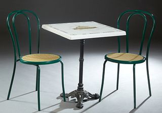 French Square "Danny Boat Cafe" Bistro Table, 20th c., on an iron base, together with two iron bistro chairs with faux caned seats, in green paint, Ta