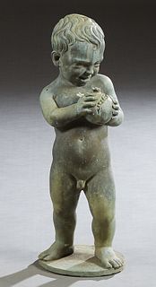 Patinated Lead Fountain Figure, early 20th c., of a putto admiring a pomegranate, on an integral circular base, H.- 25 in., Dia.- 9 in.