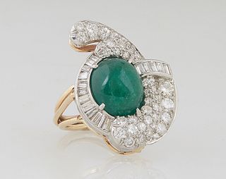 Lady's 14K Yellow Gold Dinner Ring, with an oval cabochon 10 ct. emerald, within a swirled border of round and baguette diamonds, on a split shouldere