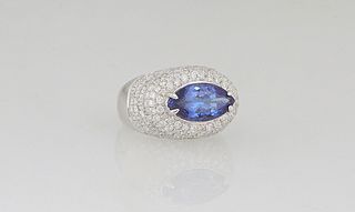 Lady's 14K White Gold Dinner Ring, with a marquise 4.52 ct. tanzanite. atop a diamond mounted domed top, on a tapered band, total diamond wt.- 2.82 ct
