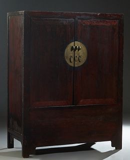 Chinese Ming Style Carved Elm Armoire, 19th c., the two large doors with brass lock plates and pulls, enclosing an interior with a belt of two drawers