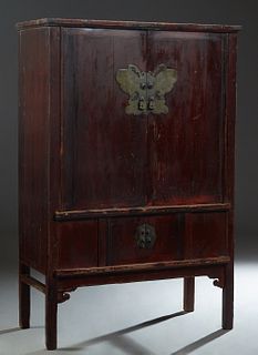 Chinese Dark Red Lacquered Cypress Four Door Cabinet, c. 1875, the double upper doors with bronze butterfly lock plates, over two small central doors 