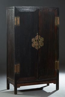 Chinese Carved Ironwood Armoire, 18th c., Northern China, the long double doors with bronze lock plates, on block legs, H.- 64 3/4 in., W.- 45 in., D.