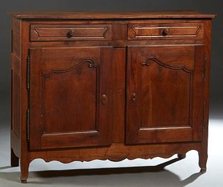 French Louis XV Style Carved Cherry and Oak Sideboard, 19th c., the canted corner top over two frieze drawers, above double cupboard doors with iron f