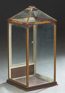 American Carved Oak Table Top Display Case, c. 1900, the sloping peaked top with four glazed panels, over glazed sides and door, on a stepped plinth b