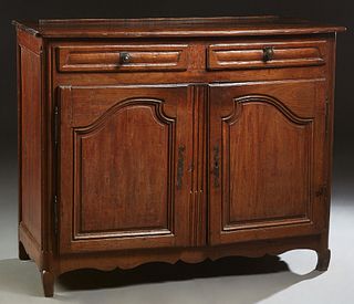 French Provincial Carved Oak Louis XV Style Sideboard, 19th c., the rounded corner ogee edge top over two frieze drawers and two fielded panel cupboar