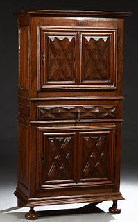 French Provincial Louis XIII Style Carved Walnut Homme Debout, 19th c., the stepped crown over a single cupboard door with iron fiche hinges and escut